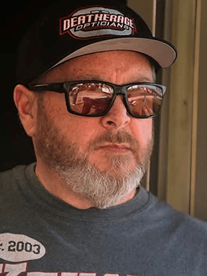 Terry Phillips Terry Phillips wearing Deatherage Certified Opticians racing glasses and a Deatherage Opticians cap.